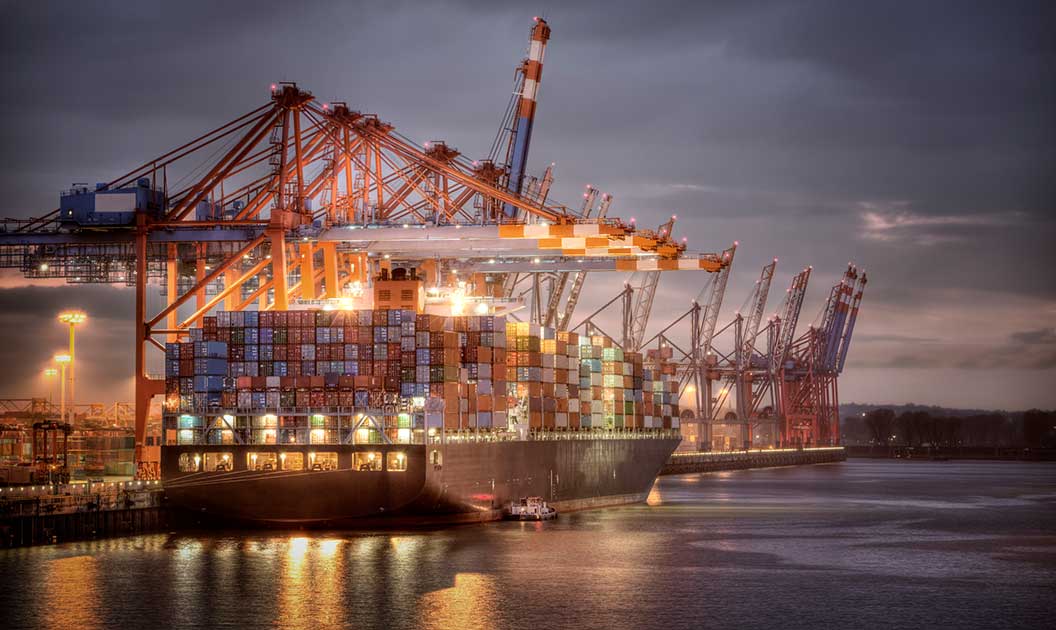 Transloading occurring at an ocean port at night