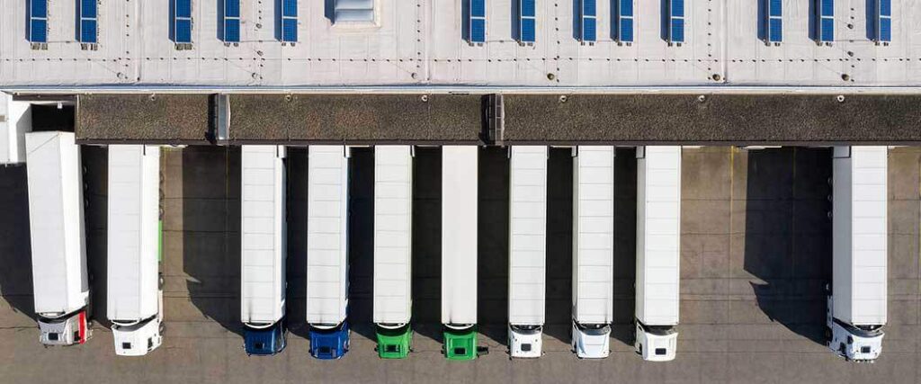 Overhead view of trucks outside a cross dock loading=