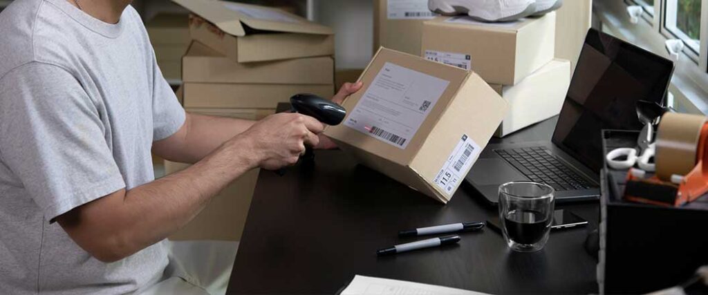 An employee scans a parcel shipment