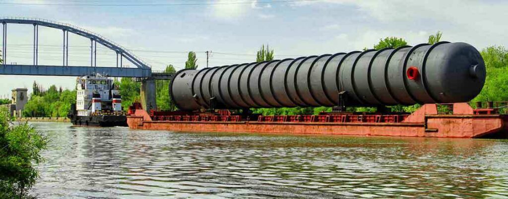 tanker barge moving along a river