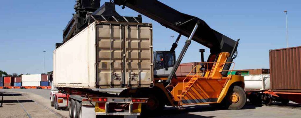 transloading agreement crane lifts shipping container onto truck chassis