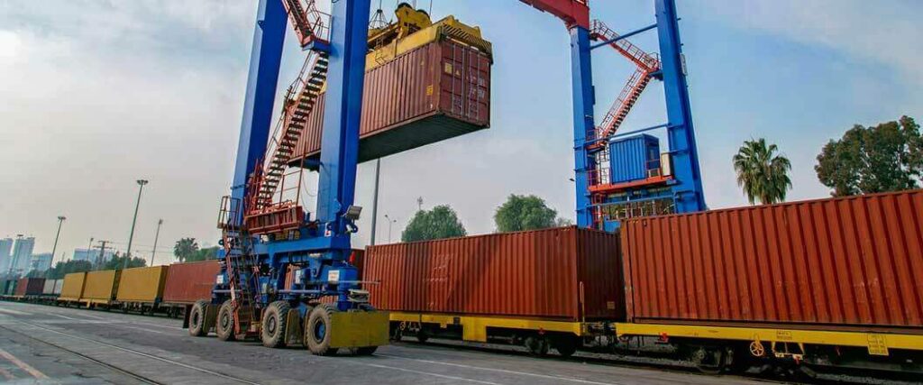 Containers with freight classified using Standard Transportation Commodity Code being loaded on rail cars